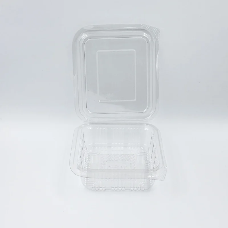 Close-up of a transparent plastic blister pack on a white surface, showing rounded corners and a perforated edge corner.