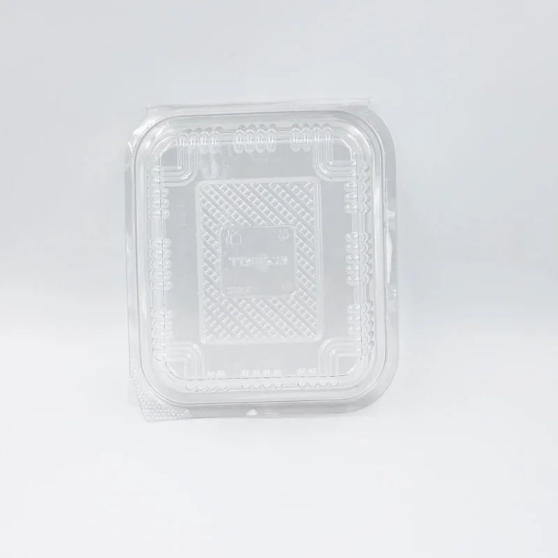 375 ml 4 Close-up of a clear plastic blister packaging with rounded corners and a textured inner surface, photographed from above-left edge.