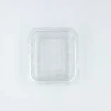 Clear transparent plastic lid with raised ridges and a textured inner surface, shown from above.