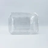 Close-up of a clear plastic food container lid on a light background, viewed from above.