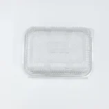Clear plastic clamshell container lid seen from above with ribbed edges and click-fastening corners